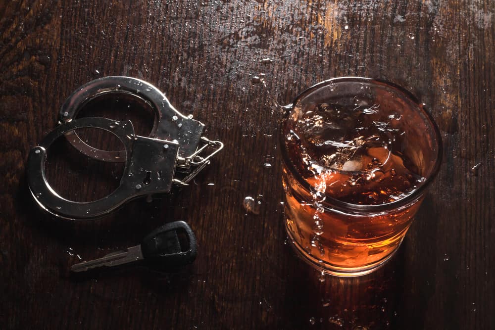 Handcuffs And A Glass Of Alcohol